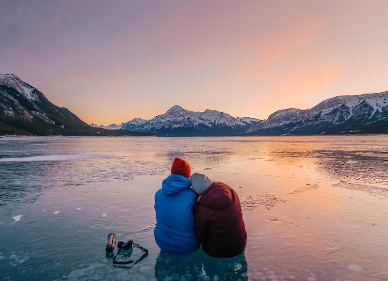 A couple enjoying sunset at Abraham Lake