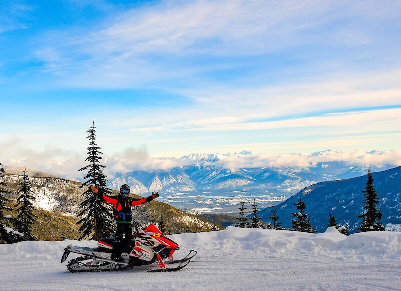 Snowmobile guest stopping to check out the views on tour
