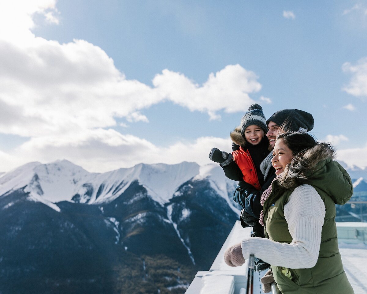 A family enjoying the views from the top of the Banff Gondola in winter