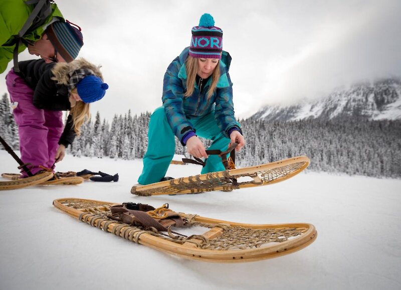 a group putting on snowshoes at lake louise