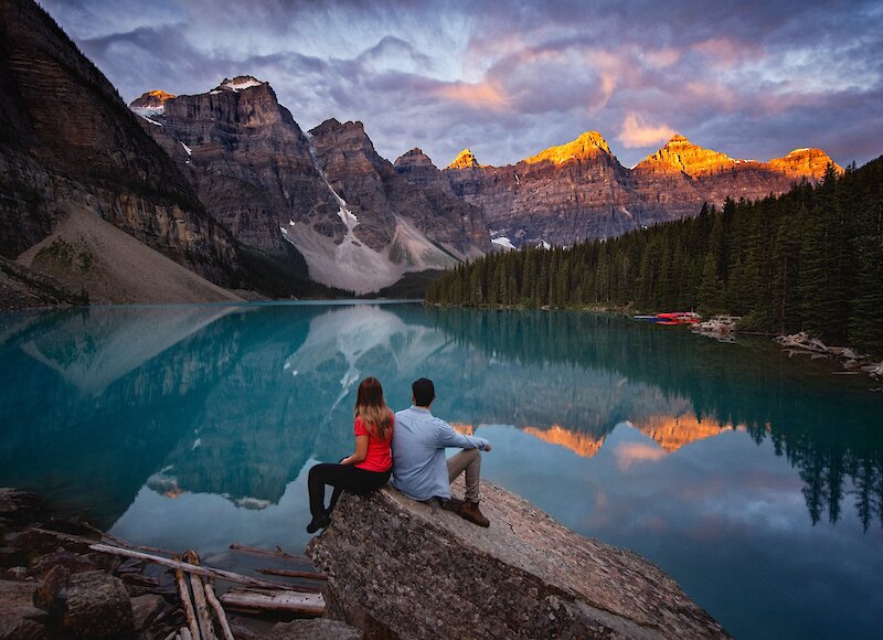 A couple watching sunrise at Moraine Lake