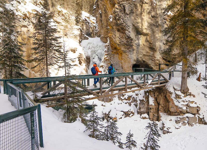 A couple walking along the boardwalk of Johnston Canyon in Banff National Park