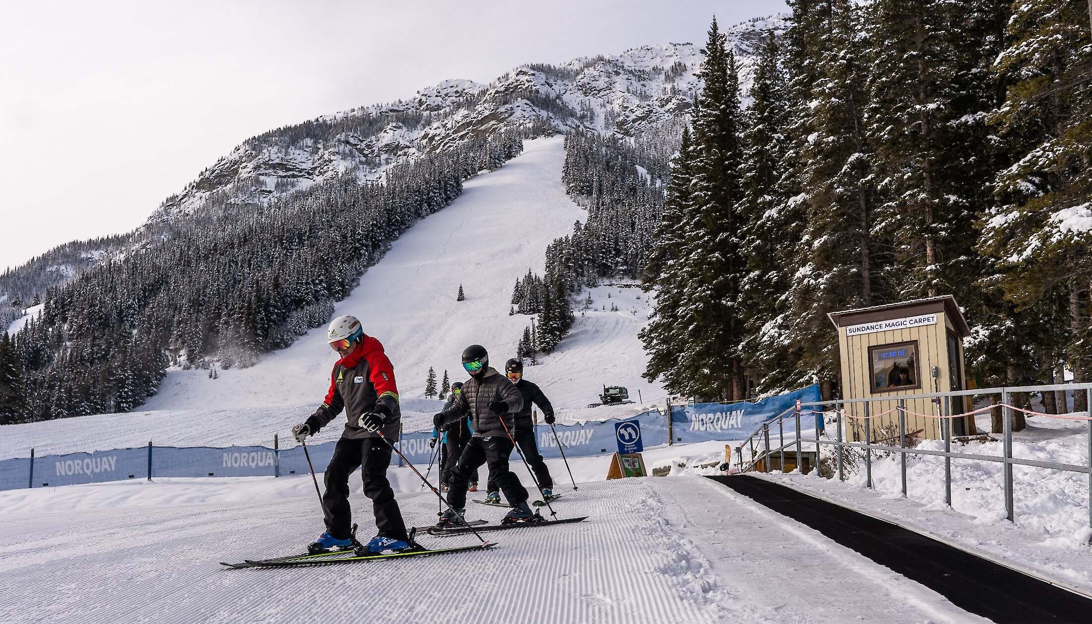 A group of beginners in a ski lesson at Mount Norquay