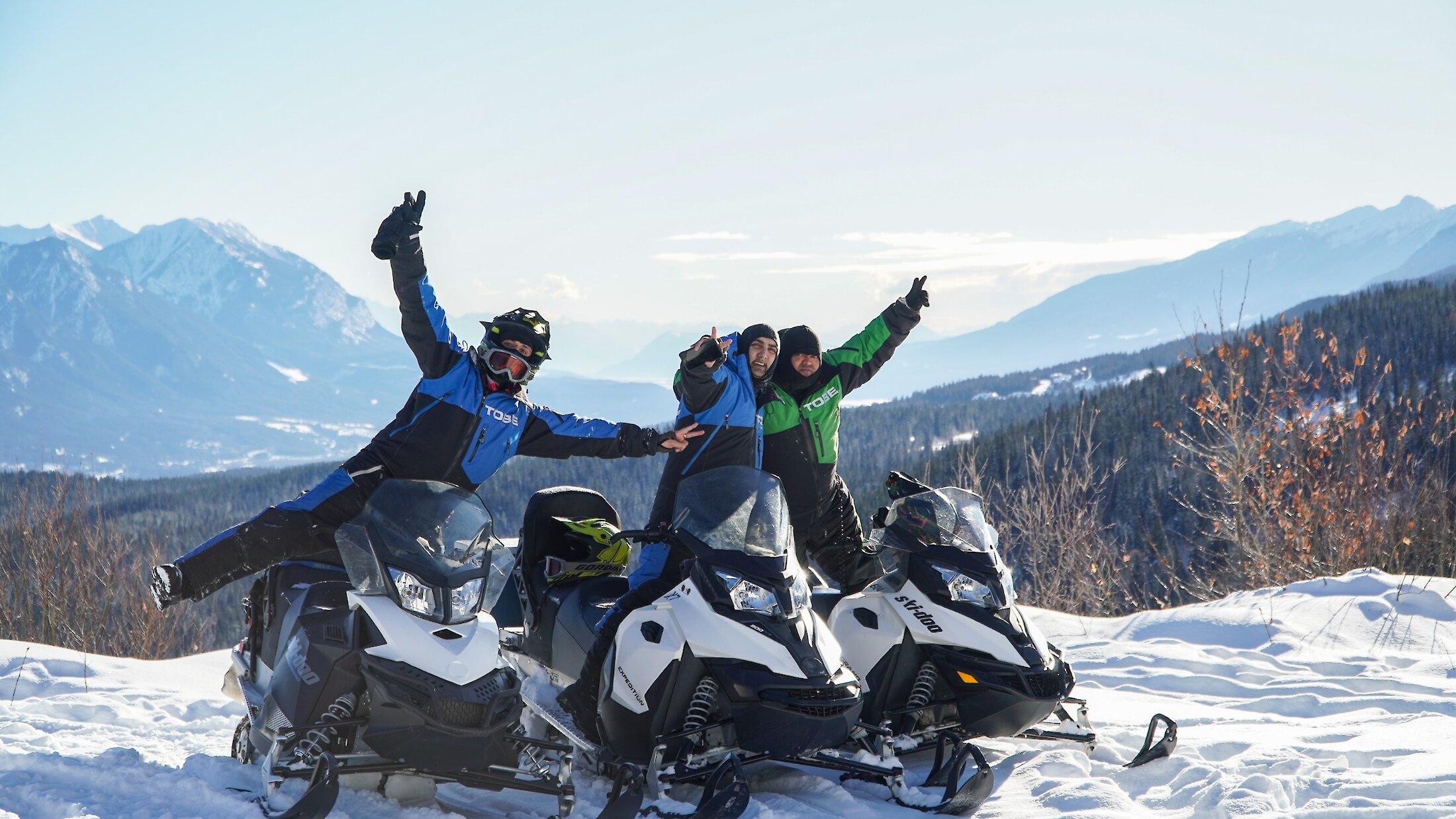 Snowmobiling at Kicking Horse Mountain Resort with a group of friends