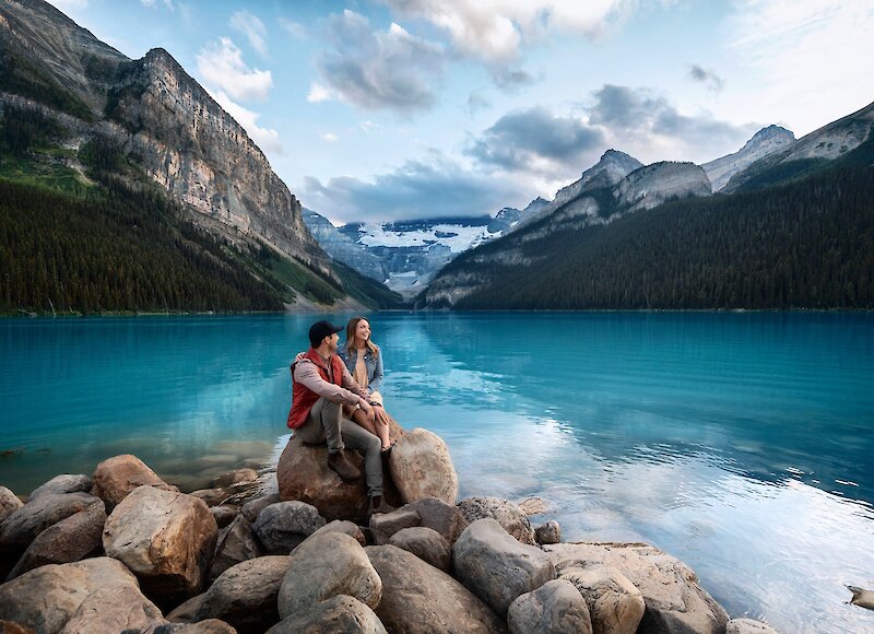 A couple admiring the view of Lake Louise in Banff National Park