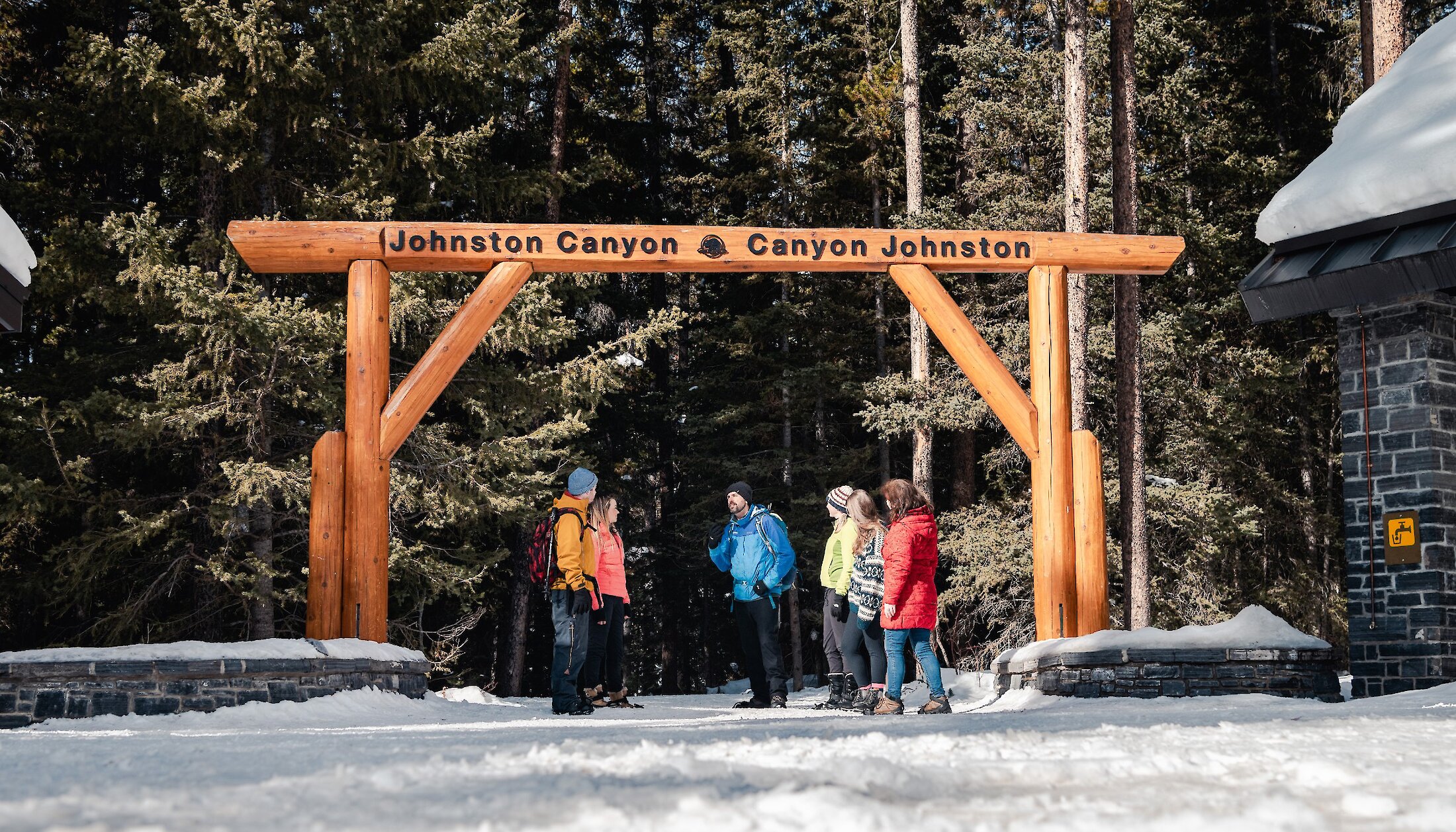 A group of hikers at the entrance to Johnston Canyon