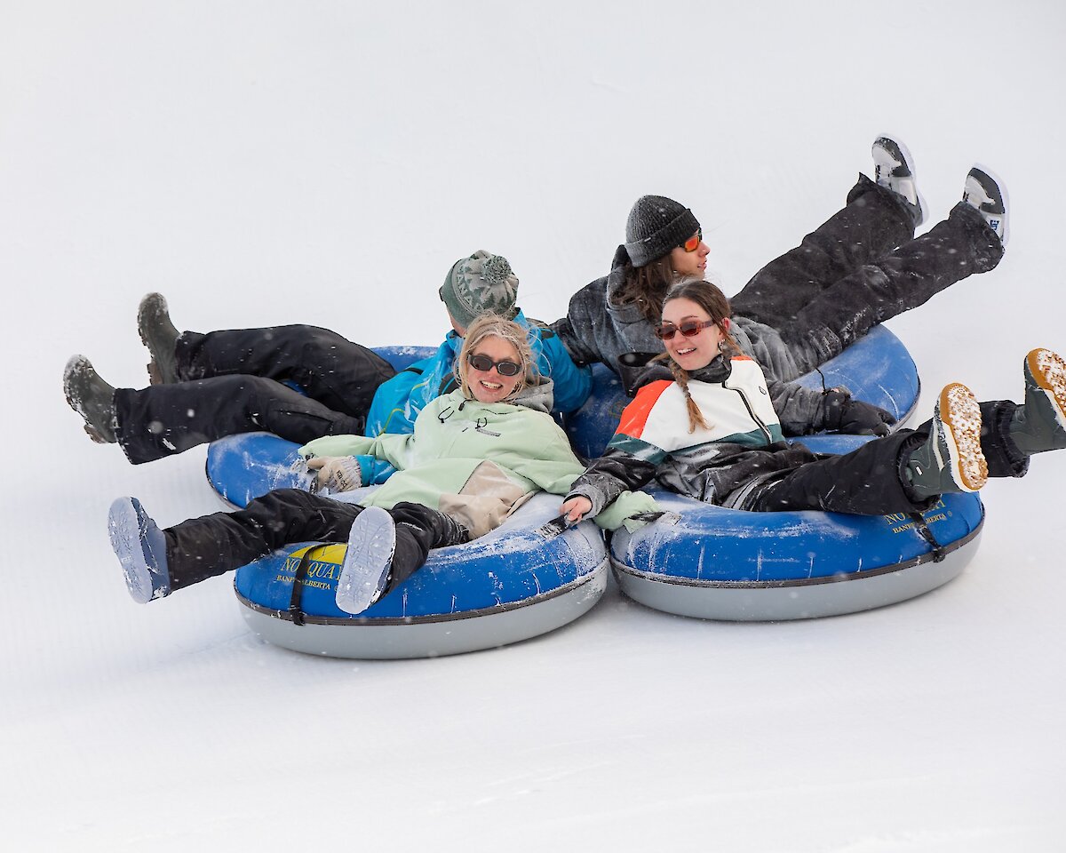 A group of friends snow tubing at Mount Norquay