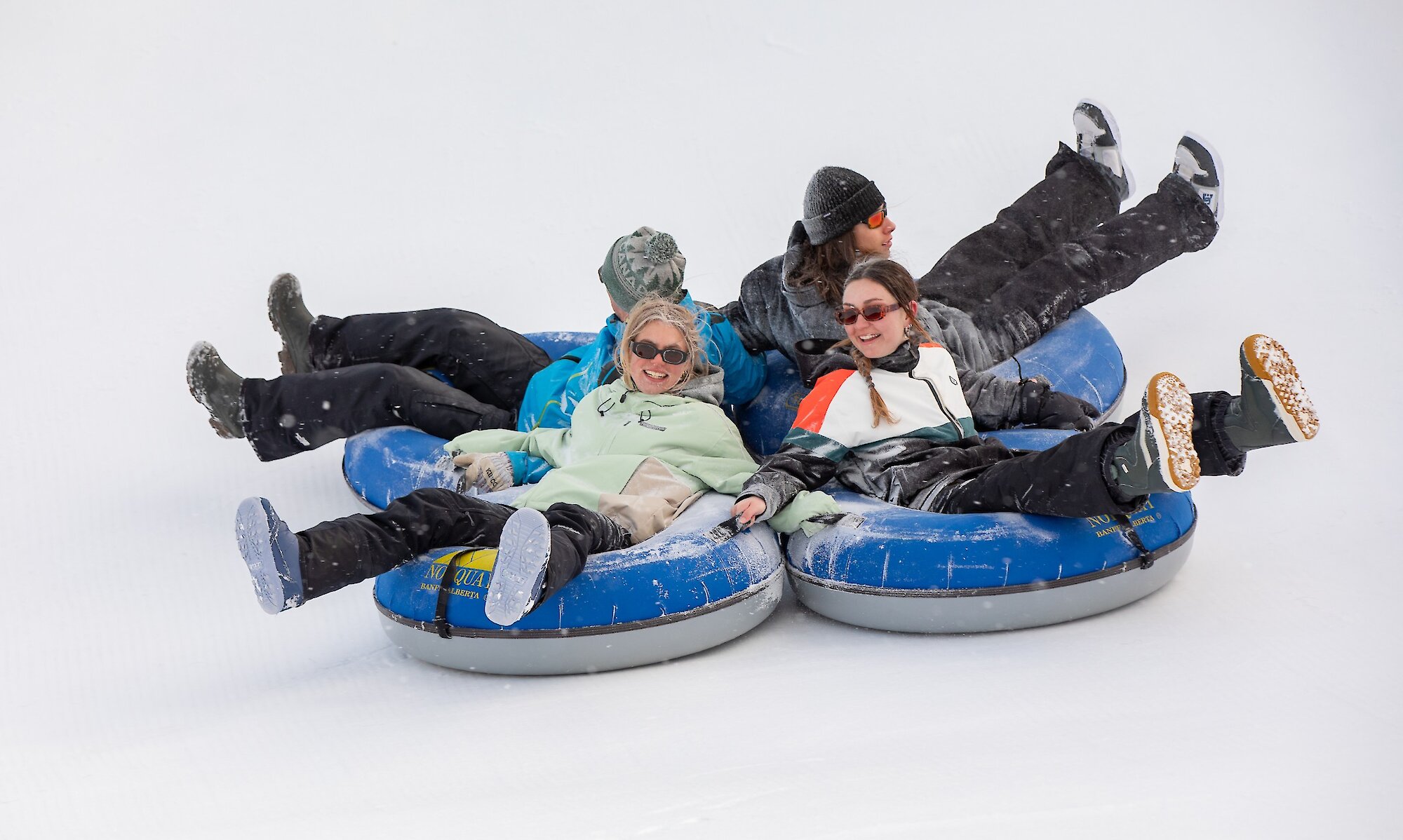 A group of friends snow tubing at Mount Norquay