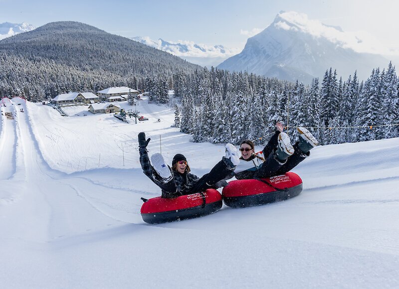 Two friends Snow Tubing at Mount Norquay