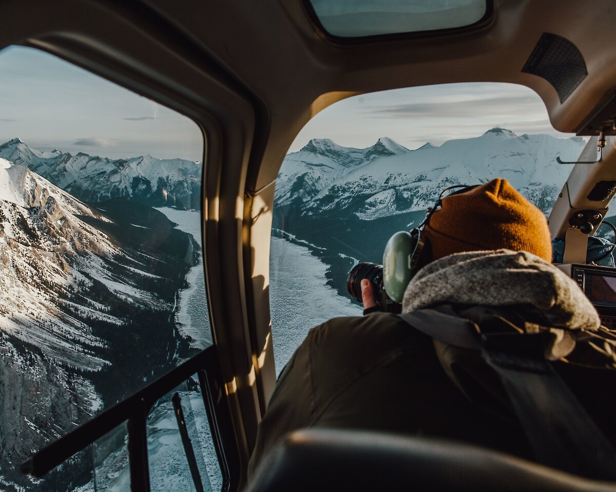 A photographer taking photos of Abraham Lake in the Canadian Rockies