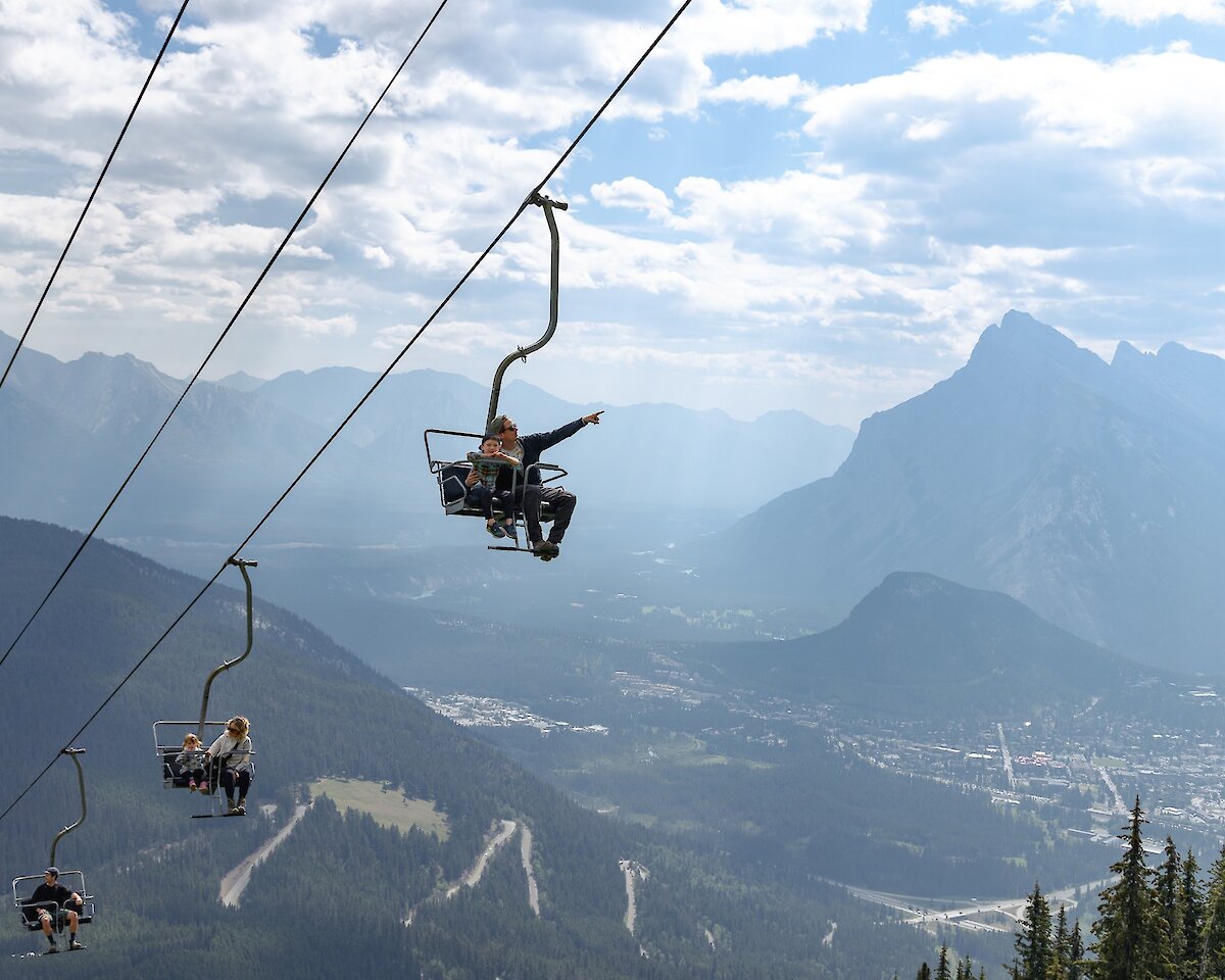 A man and child on the sightseeing chairlift over banff