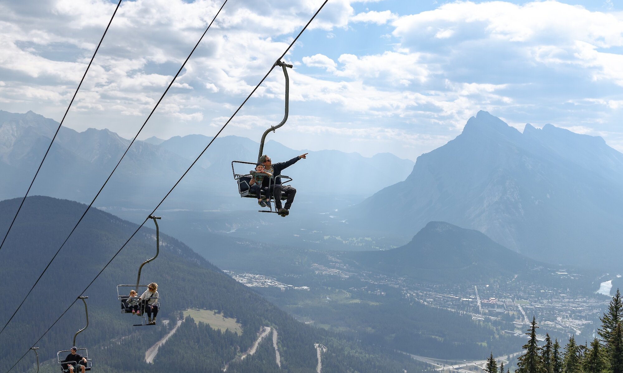 A man and child on the sightseeing chairlift over banff